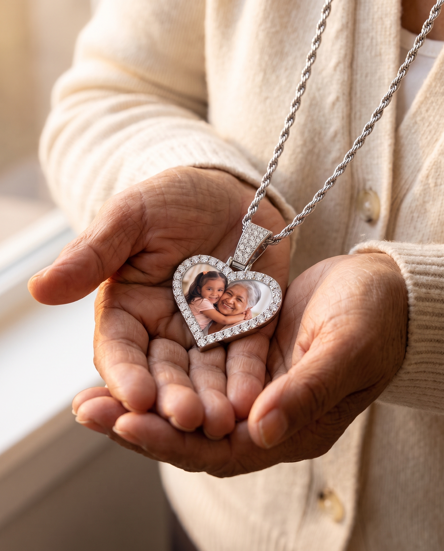 A grandmother holding the silver photo pendant in her hands